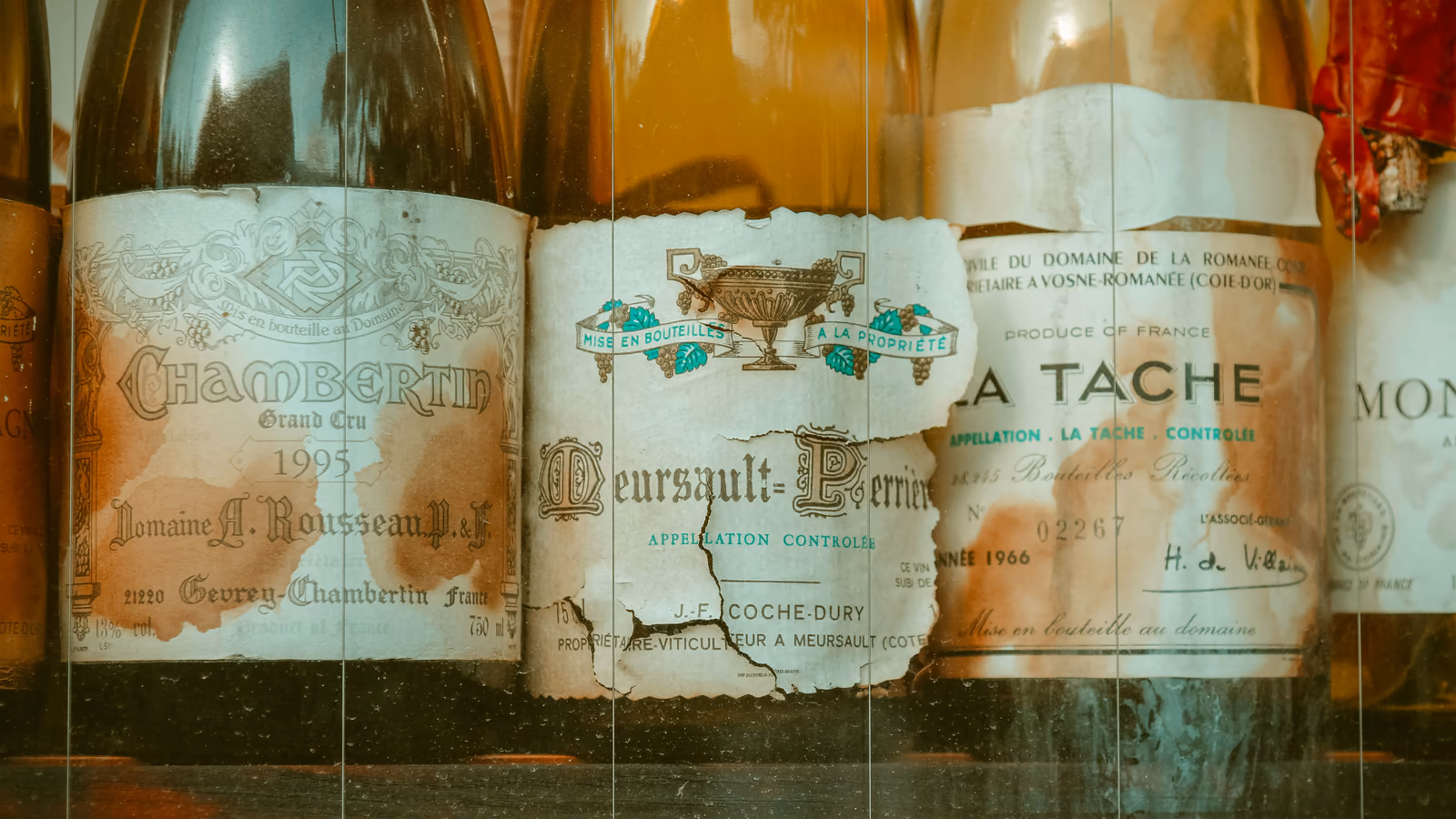 Aged Burgundy wine bottles with worn vintage labels